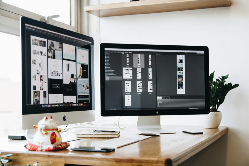 pexels photo 326501 326501 Stylish office workspace featuring dual monitors, a keyboard, notebooks, and decorative plant.